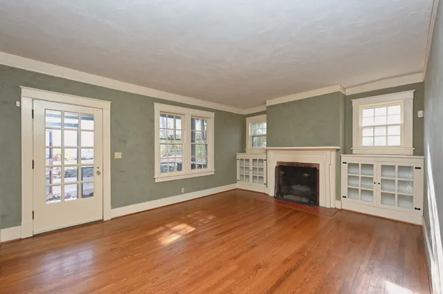 wooden floor in an empty room with a window