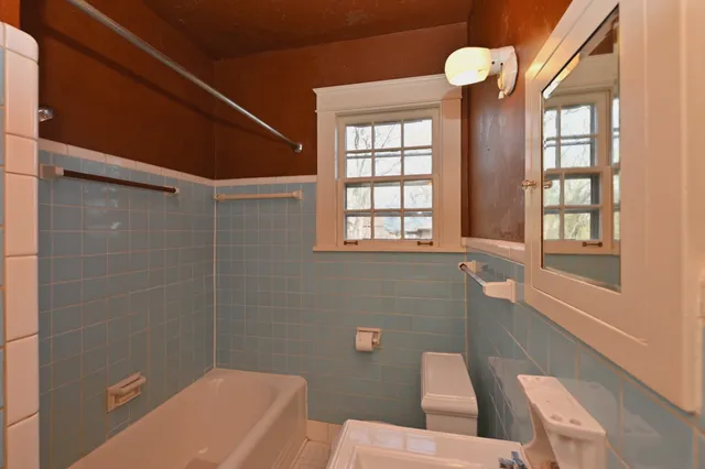 a view of a room with lots of wooden furniture