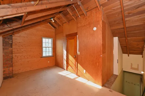 a view of a roof deck with wooden fence and floor
