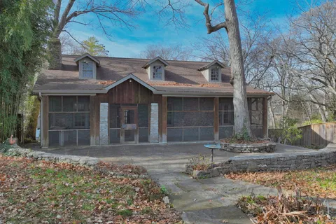 a living room with furniture fireplace and a large window