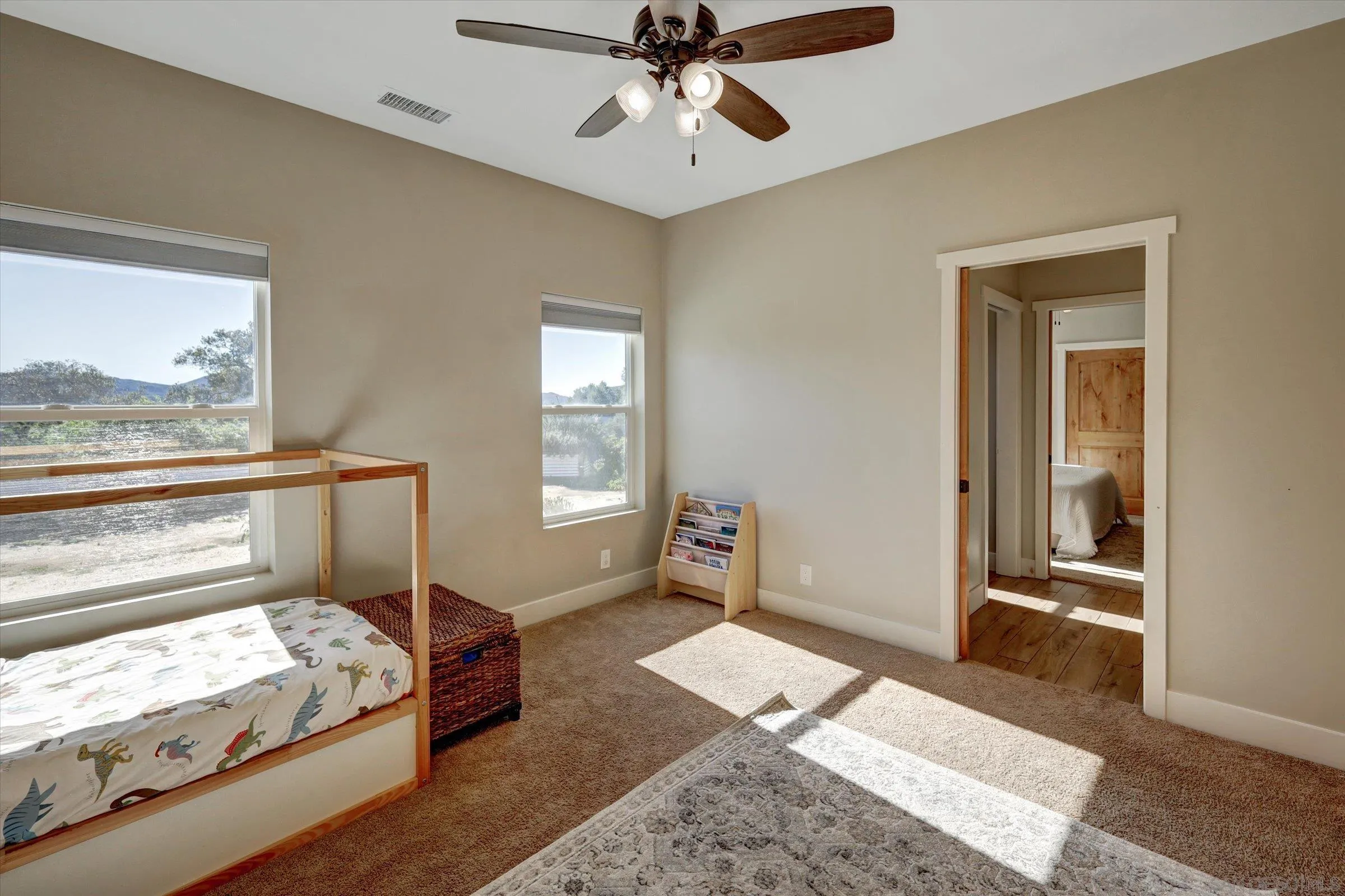 11611 Rancho Heights Road Pala, CA 92059 - Photo 17 of 43 a spacious bedroom with a bed and a window
