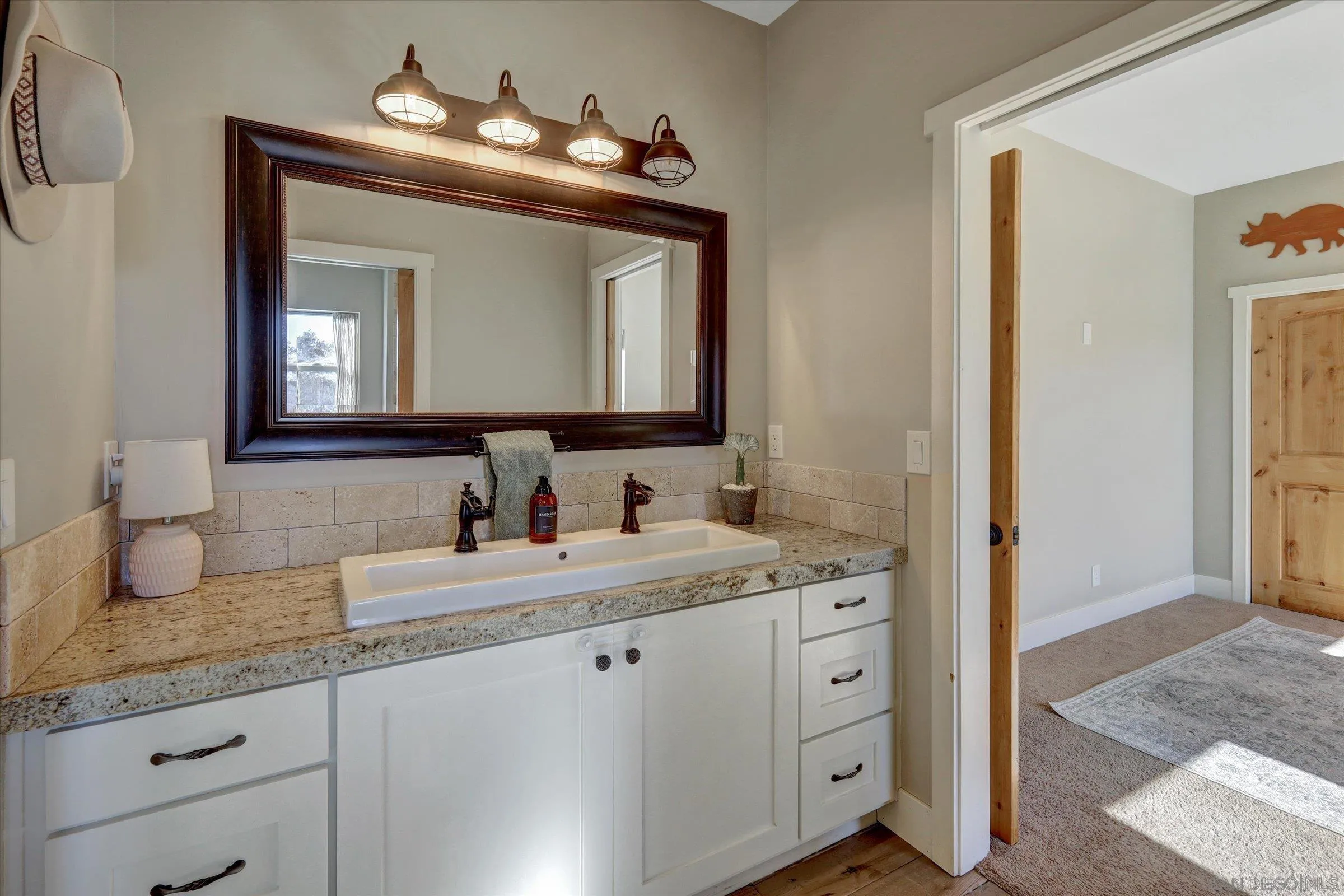 11611 Rancho Heights Road Pala, CA 92059 - Photo 18 of 43 a en suite bathroom with a granite countertop sink and a mirror