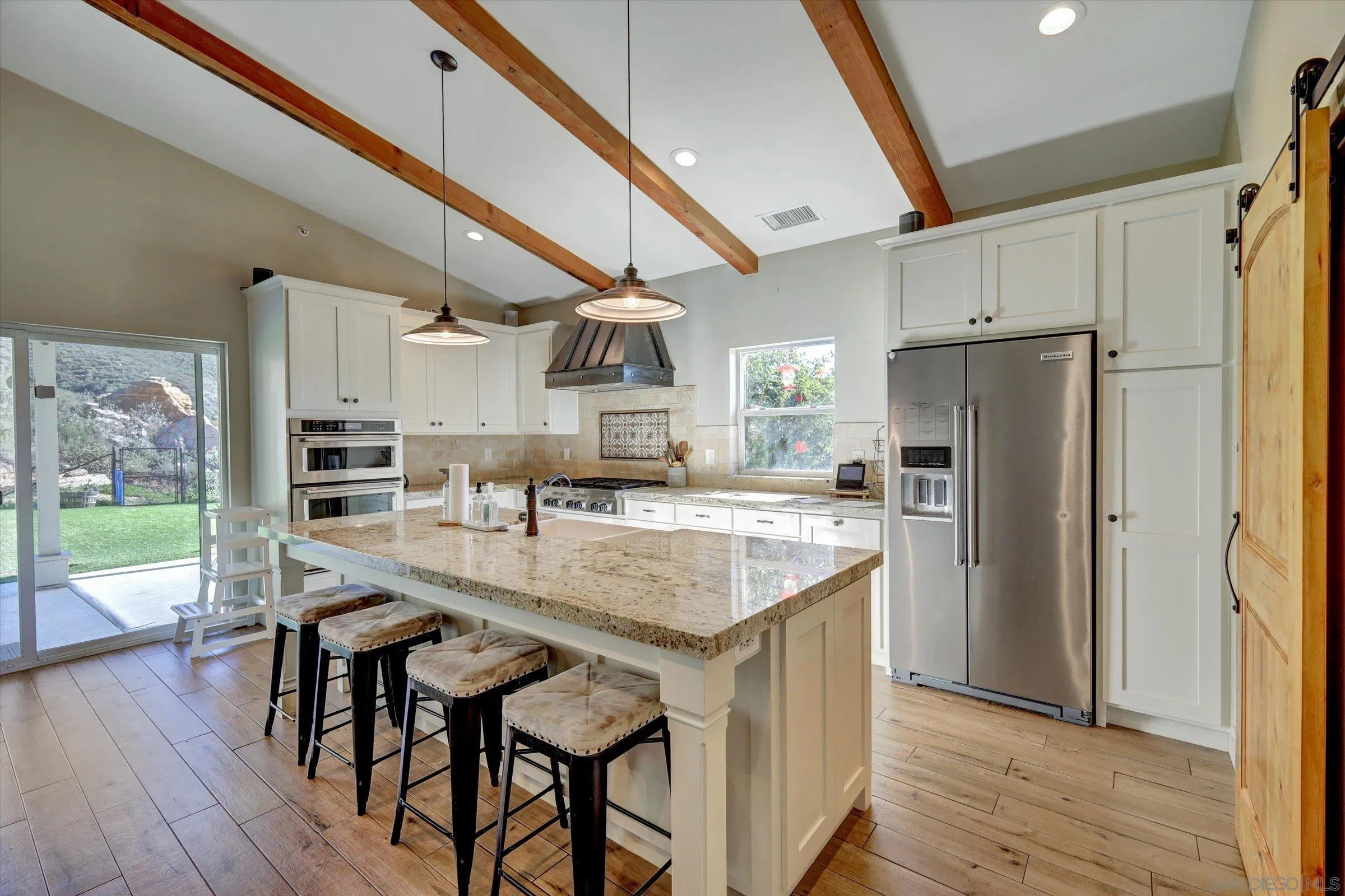 11611 Rancho Heights Road Pala, CA 92059 - Photo 2 of 43 a kitchen with stainless steel appliances granite countertop a refrigerator a sink dishwasher a stove and a oven with wooden floor