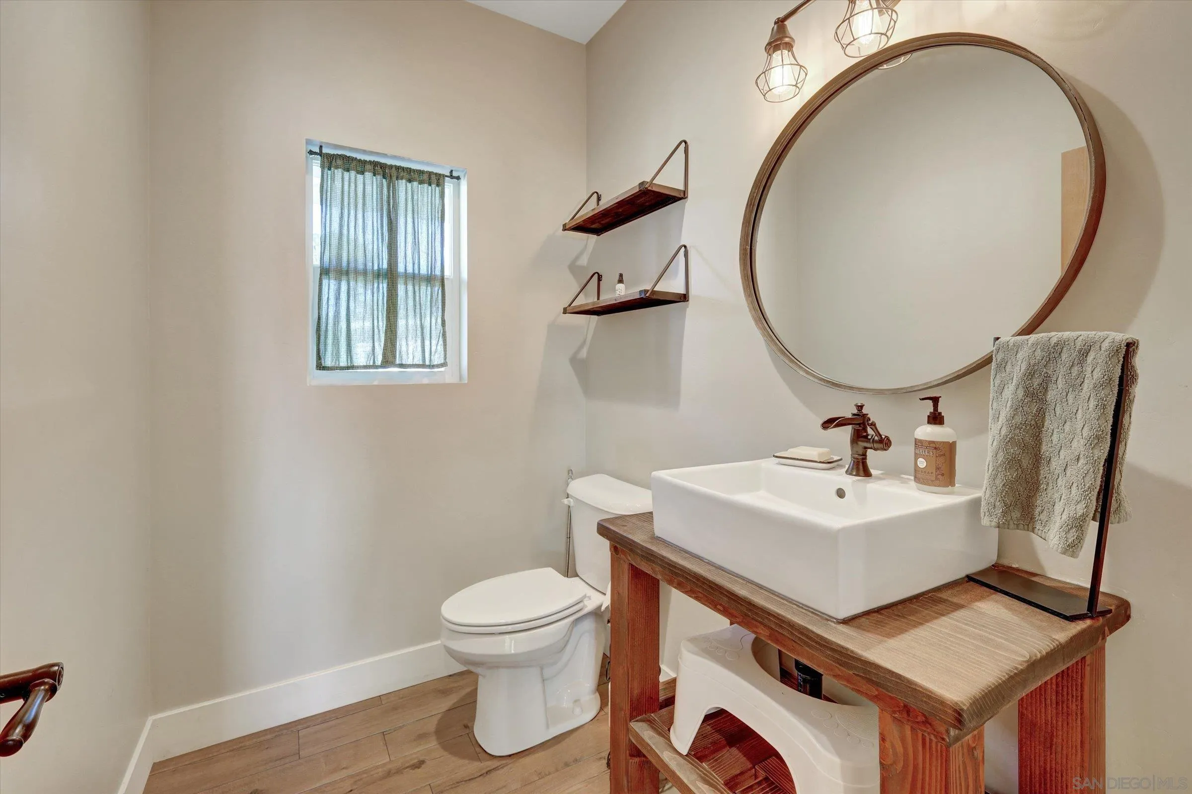 11611 Rancho Heights Road Pala, CA 92059 - Photo 24 of 43 a bathroom with a toilet sink and mirror