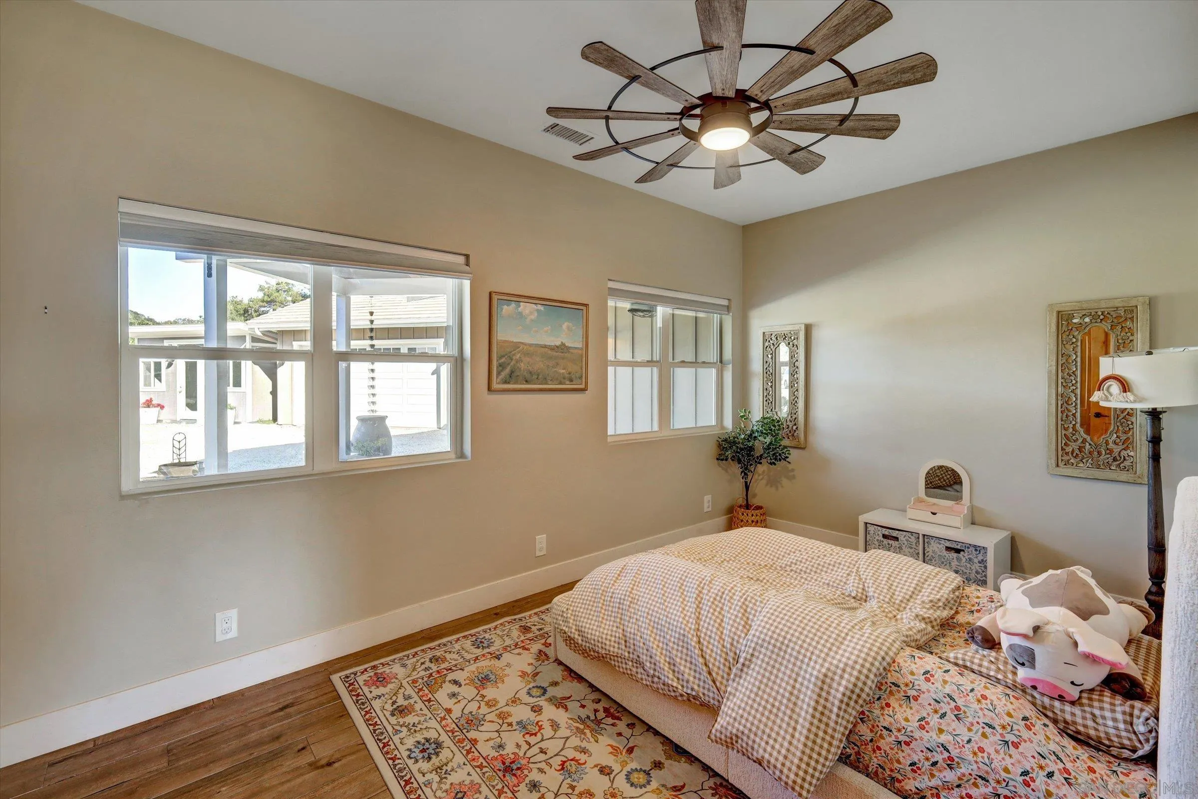 11611 Rancho Heights Road Pala, CA 92059 - Photo 25 of 43 a bedroom with a bed and a chandelier