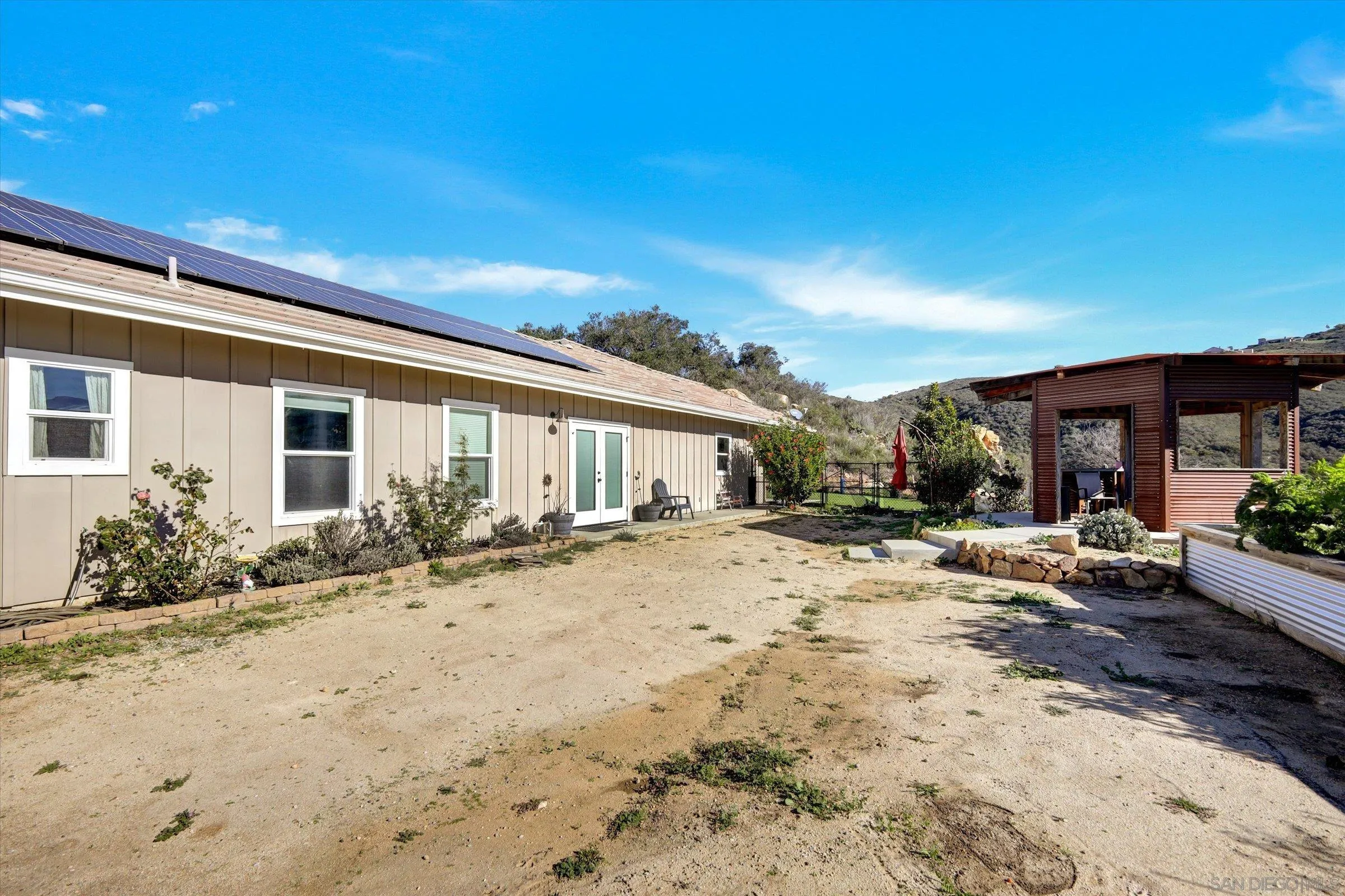 11611 Rancho Heights Road Pala, CA 92059 - Photo 27 of 43 a view of a house with backyard and sitting area