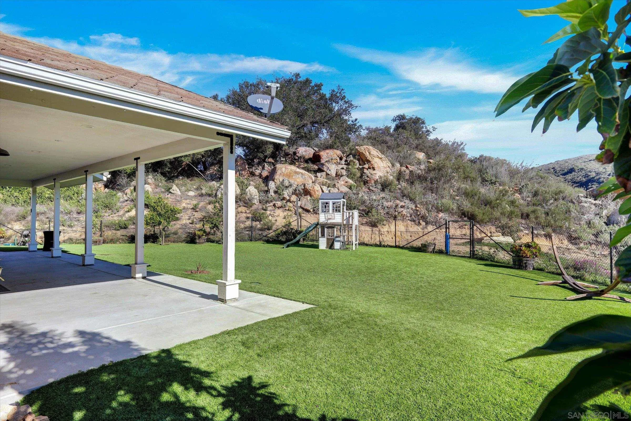 11611 Rancho Heights Road Pala, CA 92059 - Photo 31 of 43 a view of a house with backyard and porch