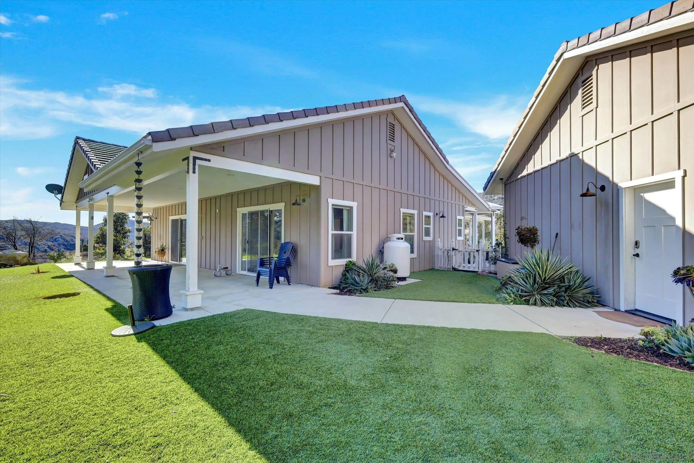 11611 Rancho Heights Road Pala, CA 92059 - Photo 34 of 43 a view of a house with a patio and a garden