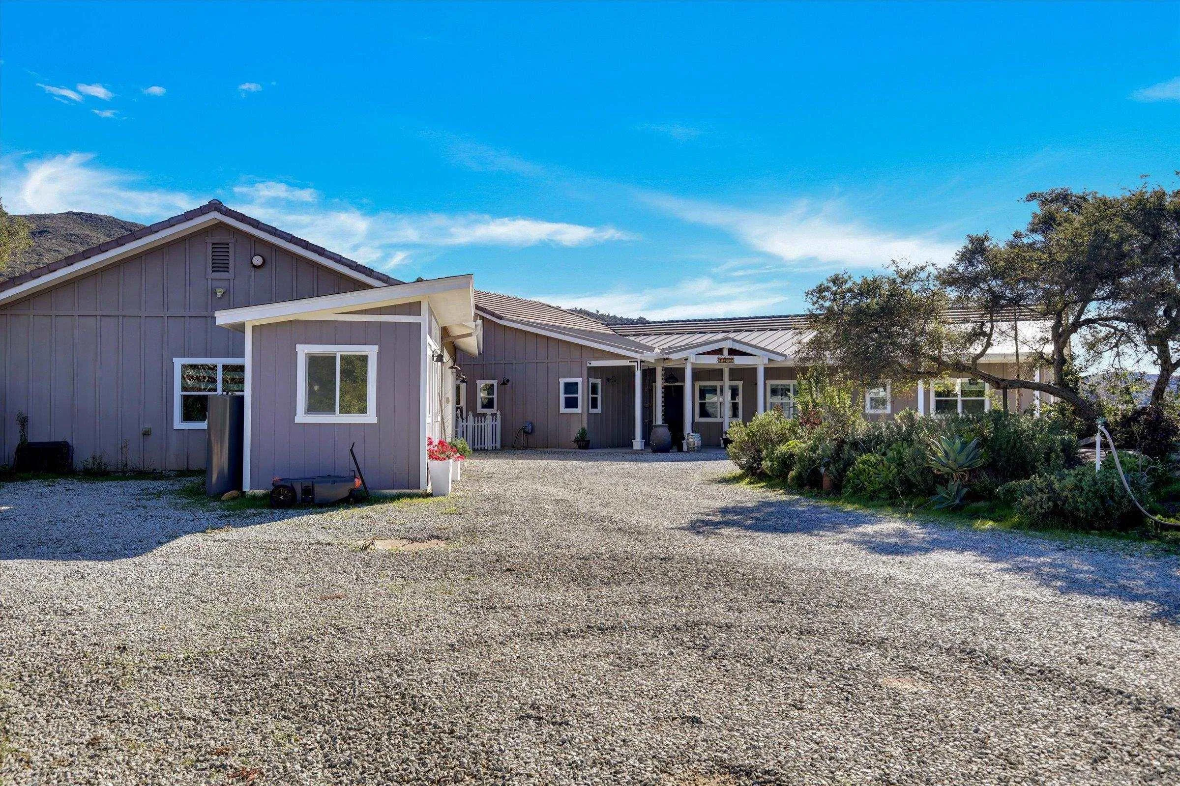 11611 Rancho Heights Road Pala, CA 92059 - Photo 36 of 43 a front view of a house with a yard and garage