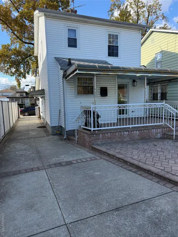 a view of a house with a patio and a yard