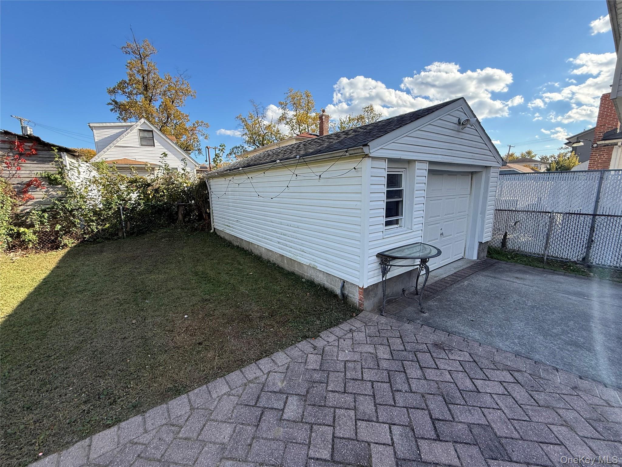 136-29 220th Place Queens, NY 11413 - Photo 16 of 45 Detached garage featuring driveway