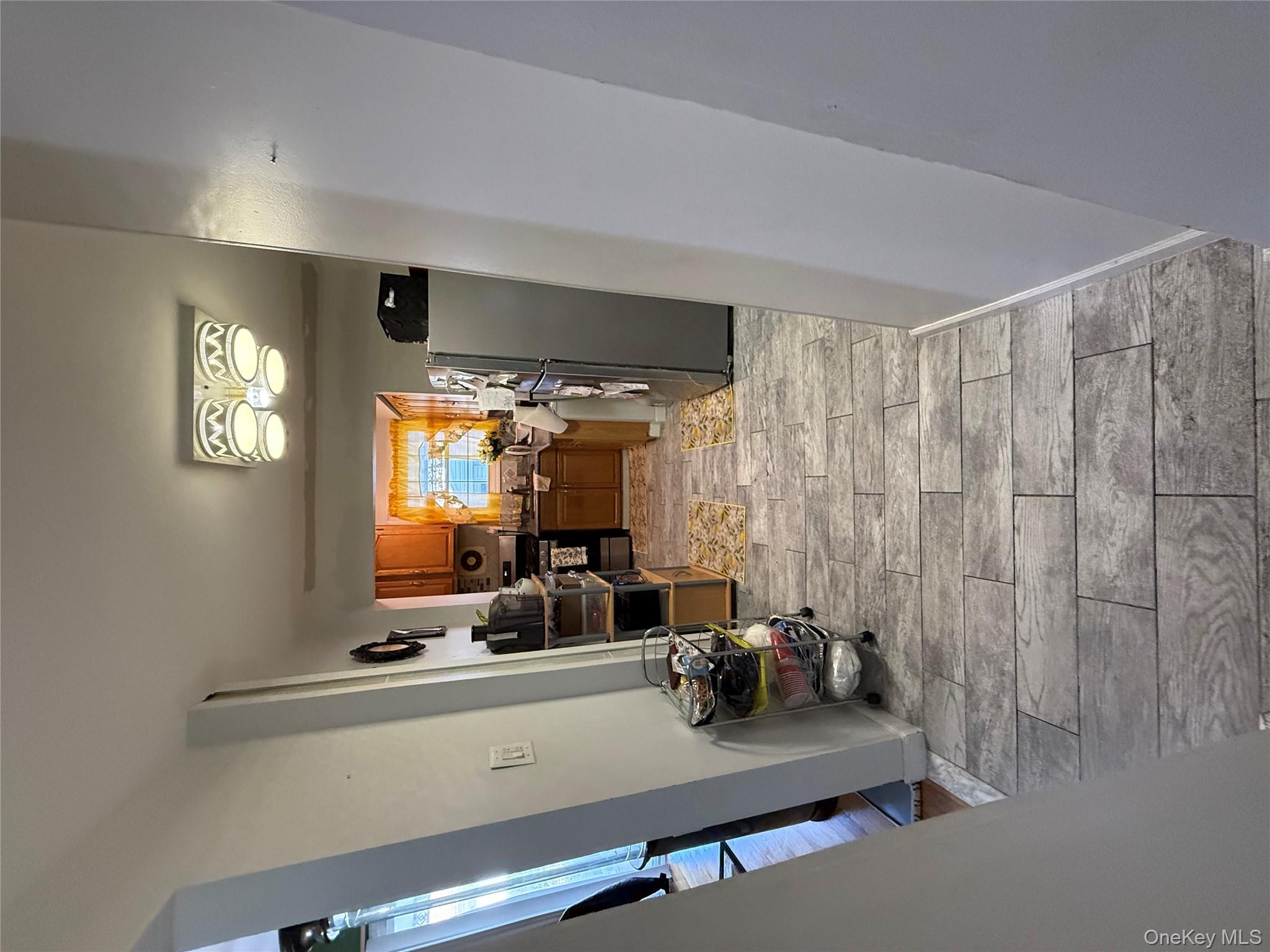 136-29 220th Place Queens, NY 11413 - Photo 17 of 45 Hall with wood tiled floors and baseboards