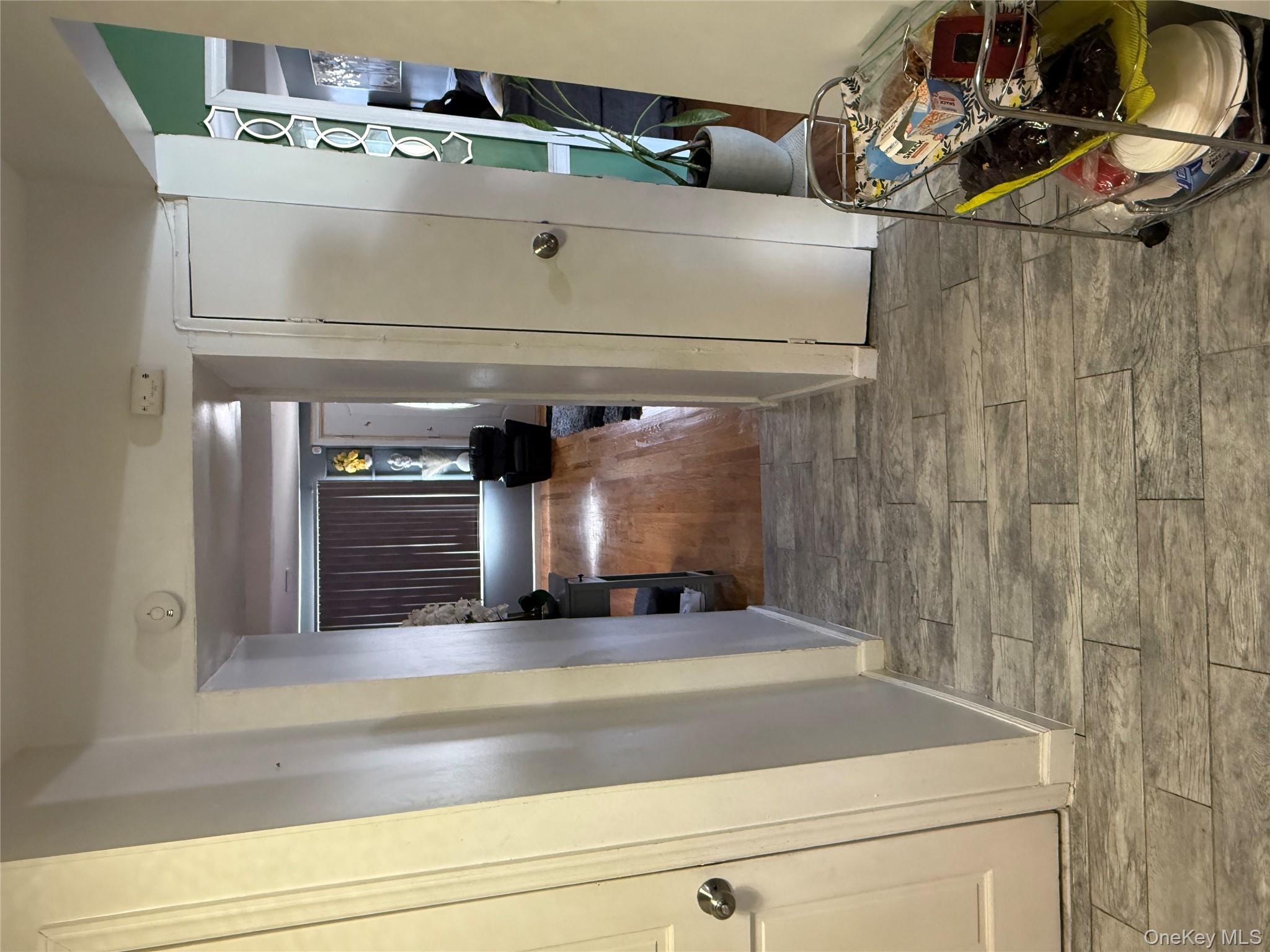 136-29 220th Place Queens, NY 11413 - Photo 21 of 45 Corridor with light wood-type flooring and baseboards