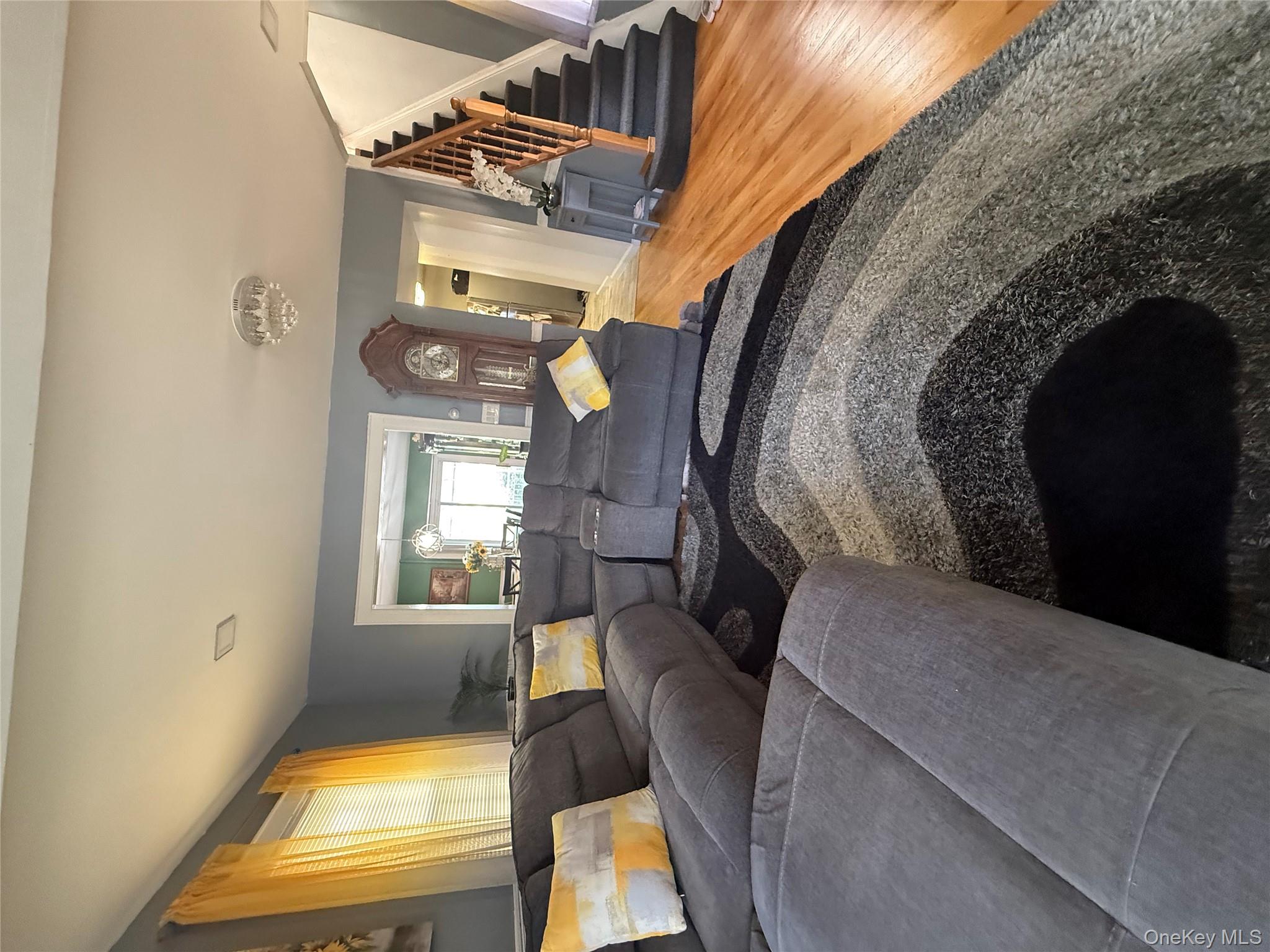 136-29 220th Place Queens, NY 11413 - Photo 24 of 45 Living room featuring stairway and light wood-style flooring