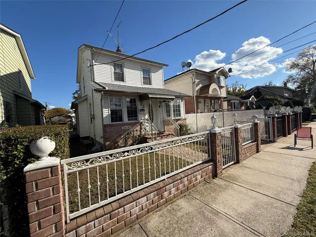 a view of a house with wooden fence