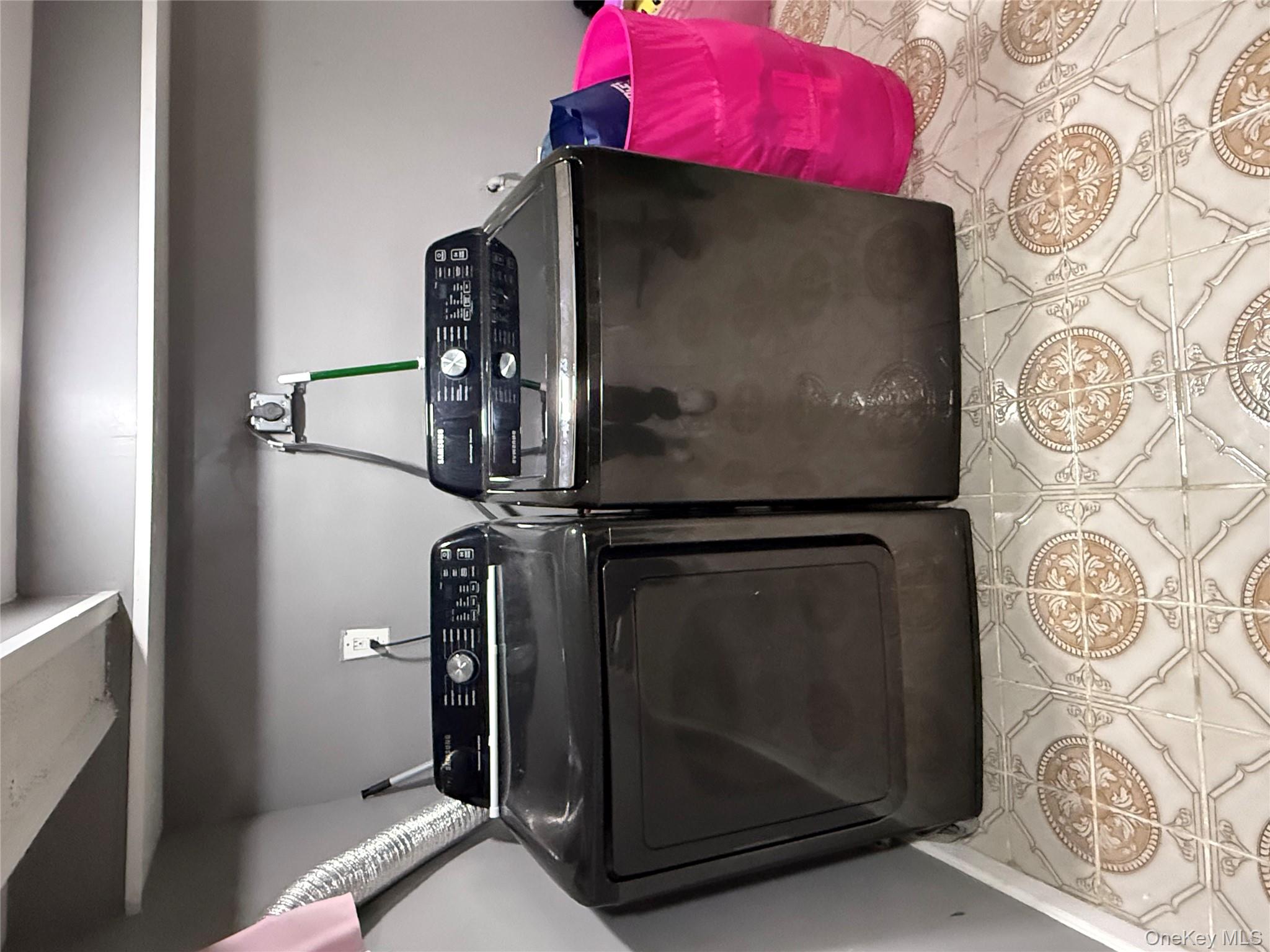 136-29 220th Place Queens, NY 11413 - Photo 43 of 45 Washroom featuring independent washer and dryer and light tile patterned flooring