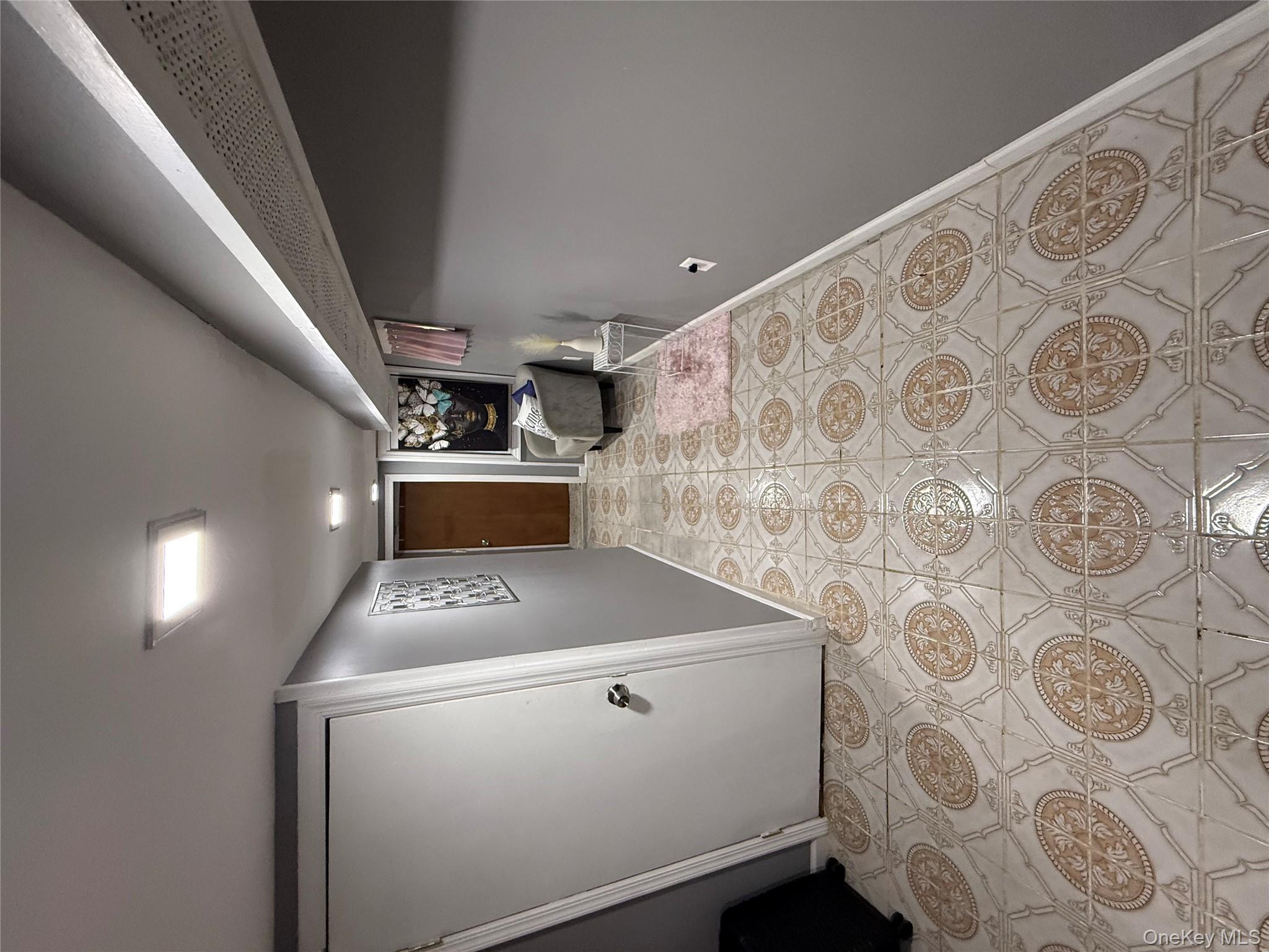 136-29 220th Place Queens, NY 11413 - Photo 44 of 45 Hallway with light tile patterned flooring