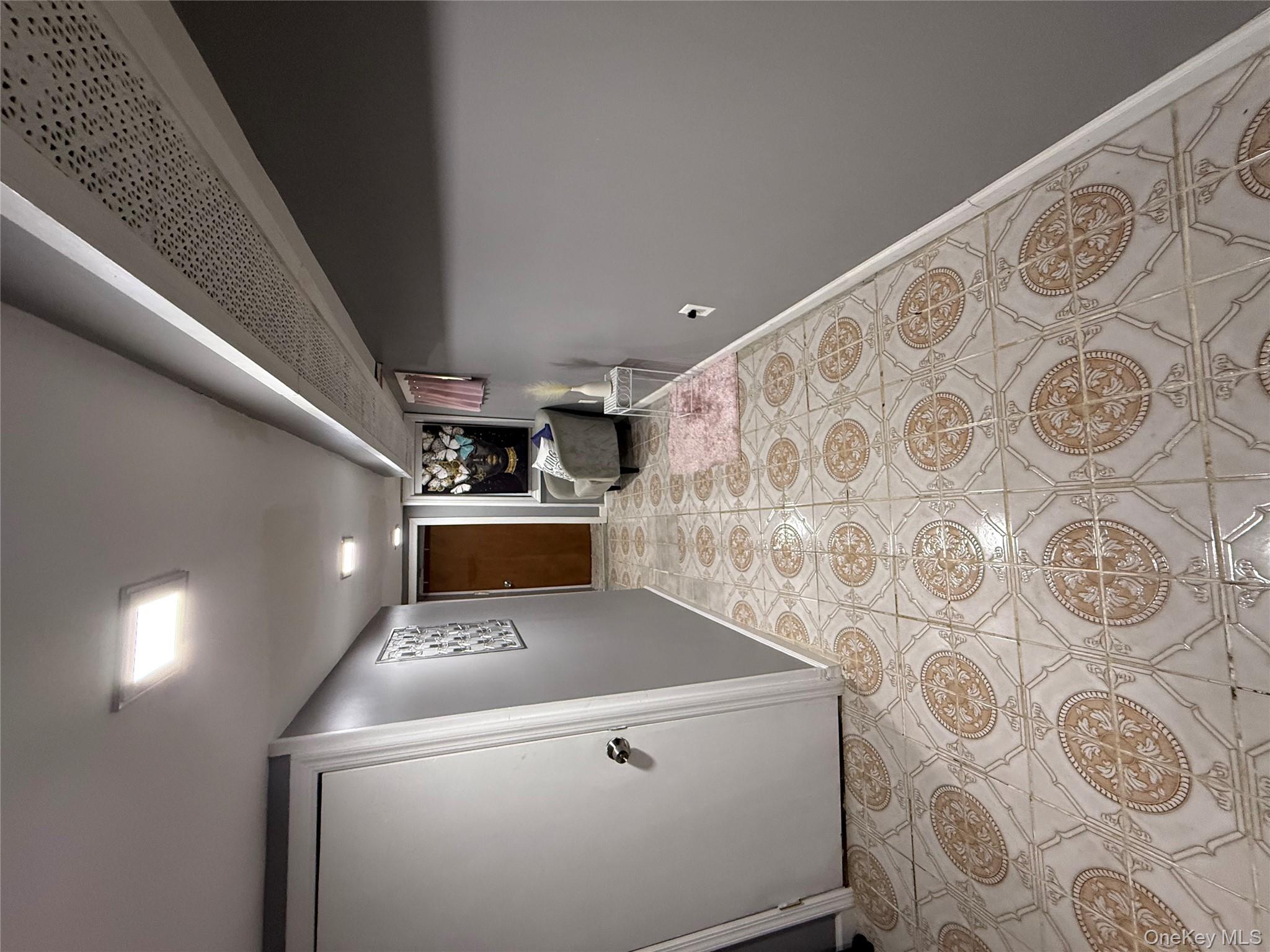 136-29 220th Place Queens, NY 11413 - Photo 45 of 45 Hallway featuring baseboards and light tile patterned floors