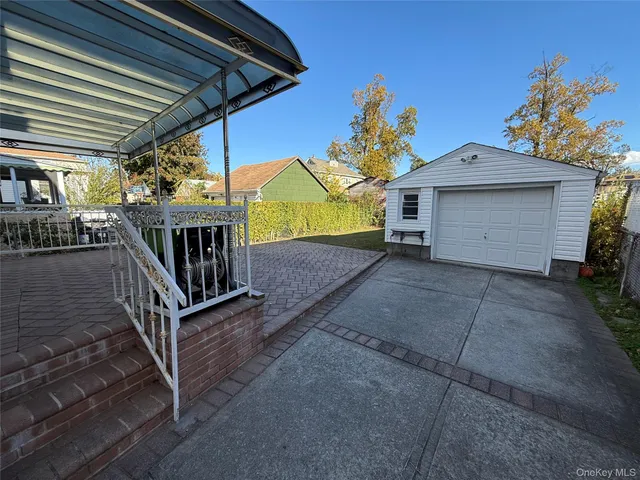a view of house with a yard and potted plants