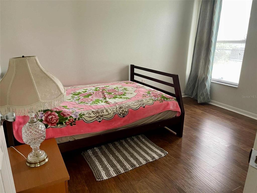 Undisclosed Address Palm Coast, FL 32164 - Photo 14 of 18 a bedroom with a bed dresser and a window