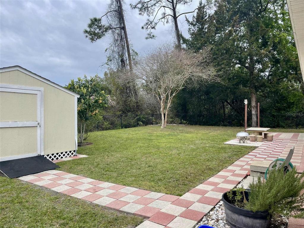 Undisclosed Address Palm Coast, FL 32164 - Photo 4 of 18 a view of a backyard with a garden