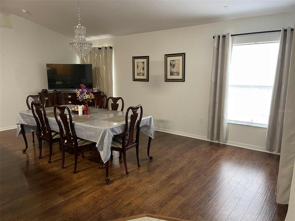 Undisclosed Address Palm Coast, FL 32164 - Photo 5 of 18 a view of a dining room with furniture window and wooden floor