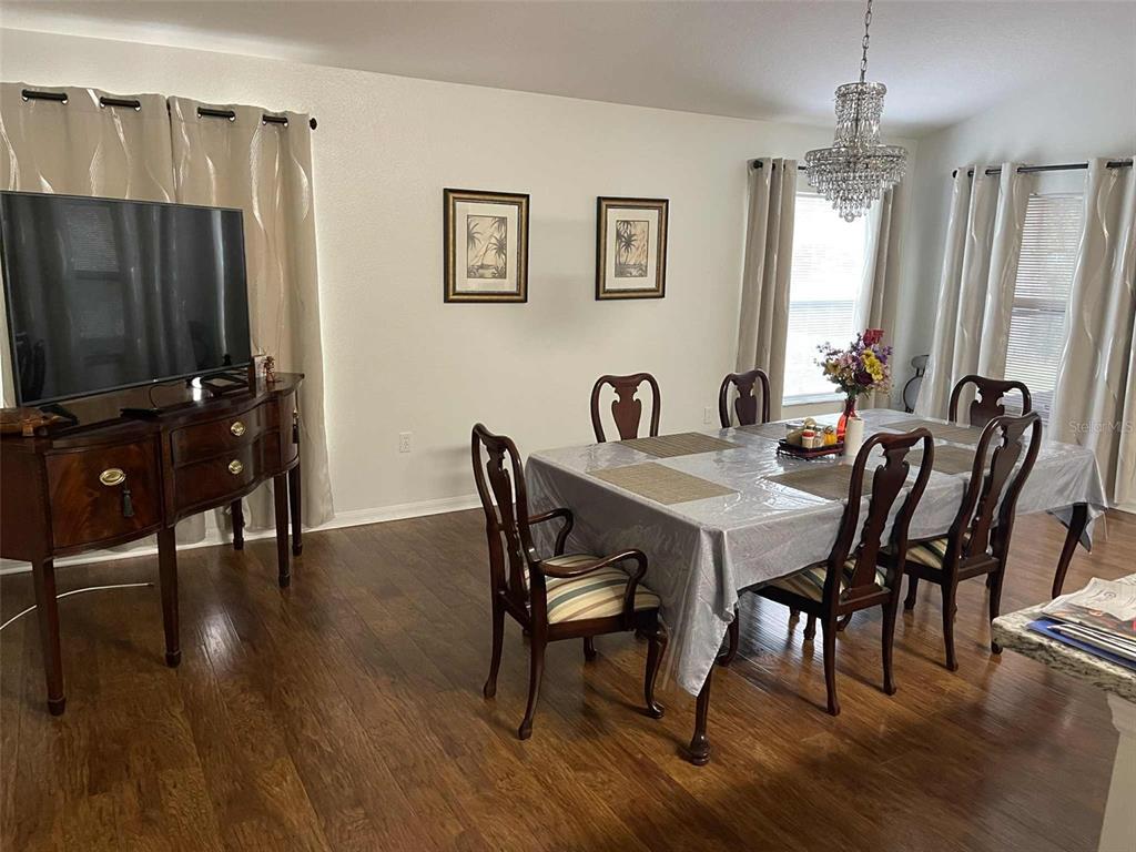 Undisclosed Address Palm Coast, FL 32164 - Photo 7 of 18 a view of a dining room with furniture window and wooden floor