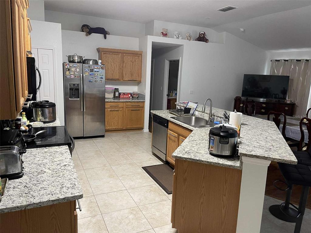 Undisclosed Address Palm Coast, FL 32164 - Photo 10 of 18 a kitchen with a granite countertop sink and stainless steel appliances
