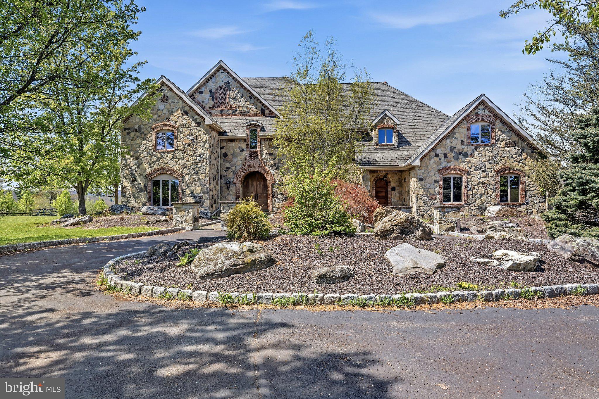 Stunning stone estate with lush grounds.