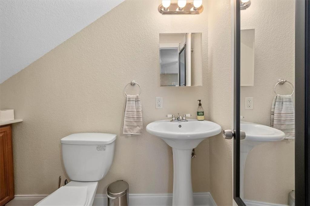 226 Bigham Street Pittsburgh, PA 15211 - Photo 20 of 25 a bathroom with a toilet sink and mirror