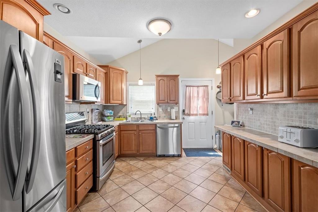 226 Bigham Street Pittsburgh, PA 15211 - Photo 10 of 25 a kitchen with stainless steel appliances granite countertop a refrigerator stove top oven and sink