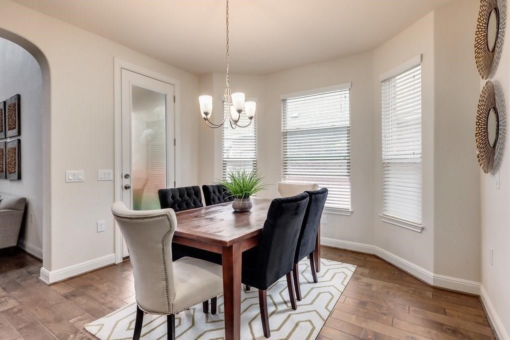 10825 Ballard Path Austin, TX 78717 - Photo 14 of 39 a view of a dining room with furniture window and wooden floor