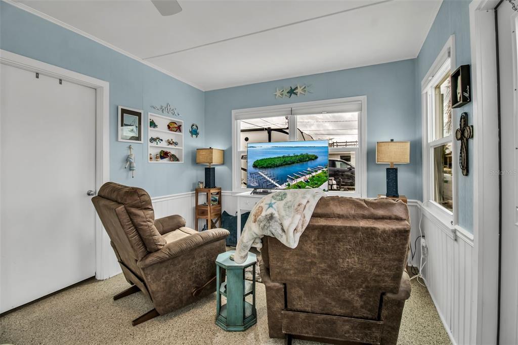 10315 Cortez Road West, Unit 123 Bradenton, FL 34210 - Photo 15 of 64 a living room with furniture and a flat screen tv