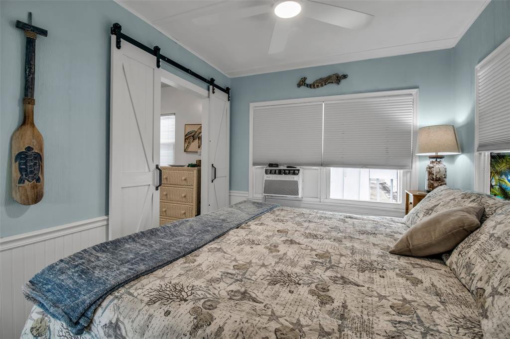 10315 Cortez Road West, Unit 123 Bradenton, FL 34210 - Photo 21 of 64 a bedroom with a bed and a refrigerator