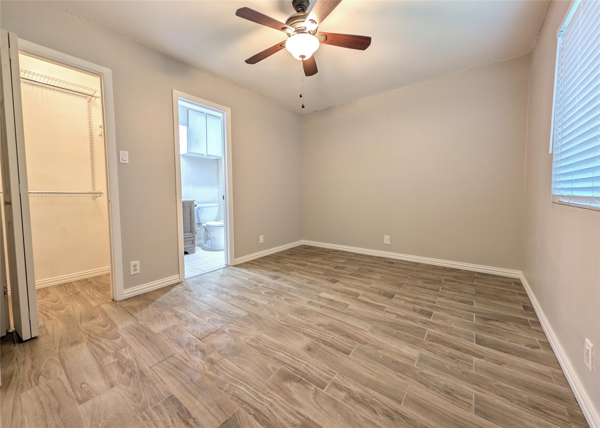 12601 Turtle Rock Road, Unit B Austin, TX 78729 - Photo 6 of 20 Primary Bedroom is on the right side when walking in the front door (furthest from the street). Extra storage bars/shelves in closet.