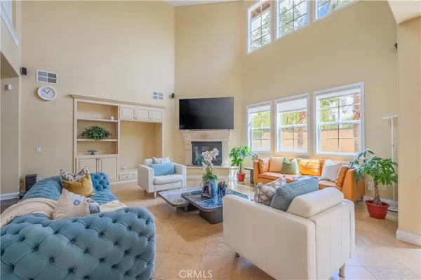 a living room with couches a dining table and chairs with outer view