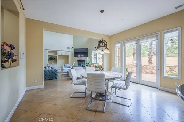a large kitchen with kitchen island a sink a counter top space stainless steel appliances and cabinets
