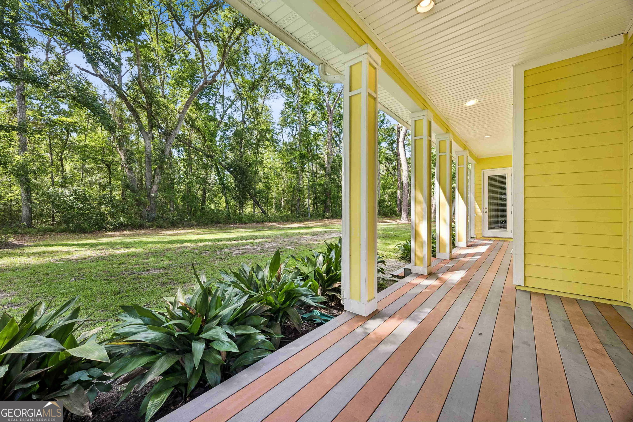 706 Hopewell Point Road White Oak, GA 31568 - Photo 67 of 84 This quiet side porch creates a private outdoor escape, surrounded by mature landscaping and the beauty of the property's wooded setting.