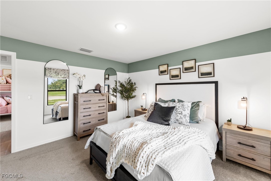 24 Southwest 15th Terrace Cape Coral, FL 33991 - Photo 12 of 14 a bedroom with a bed and a window