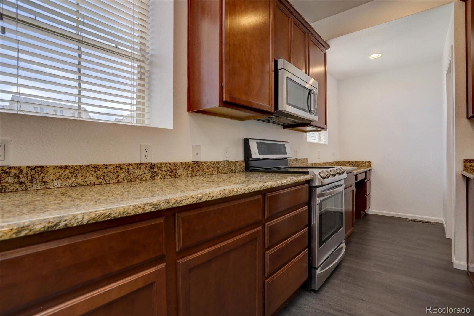 9520 Halstead Lane Lone Tree, CO 80124 - Photo 10 of 25 a kitchen with stainless steel appliances granite countertop a sink and a microwave