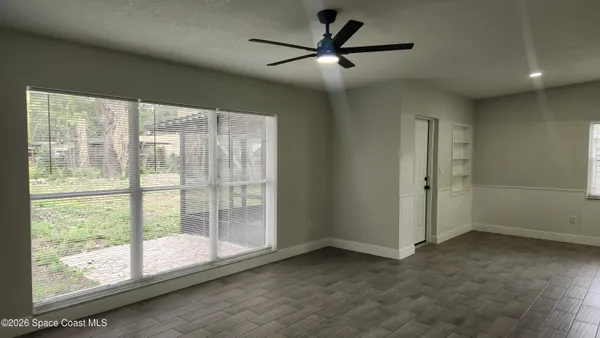 a view of an empty room with a window