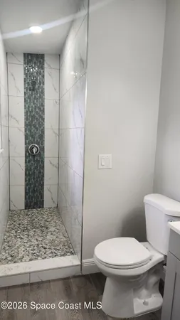 a white toilet sitting next to a bathroom sink