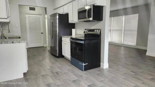 a kitchen with stainless steel appliances a refrigerator and a sink