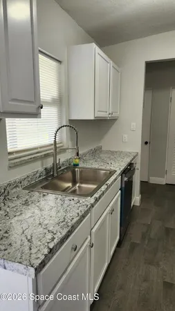 a kitchen with sink cabinets and window