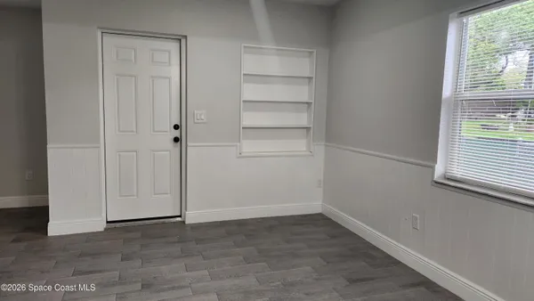 a view of an empty room with a window