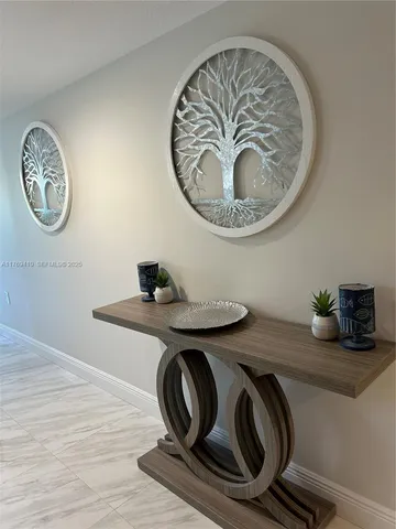 a table with a clock and wooden floor