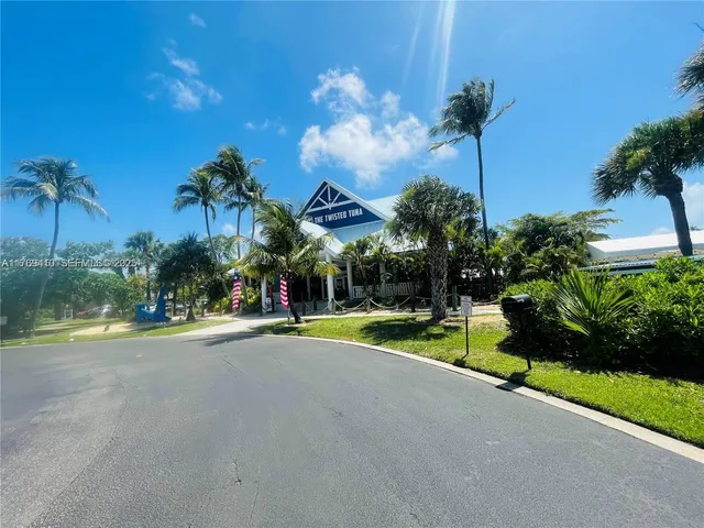 a view of a house with a swimming pool and a yard