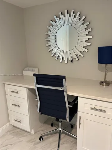 a view of a workspace with furniture