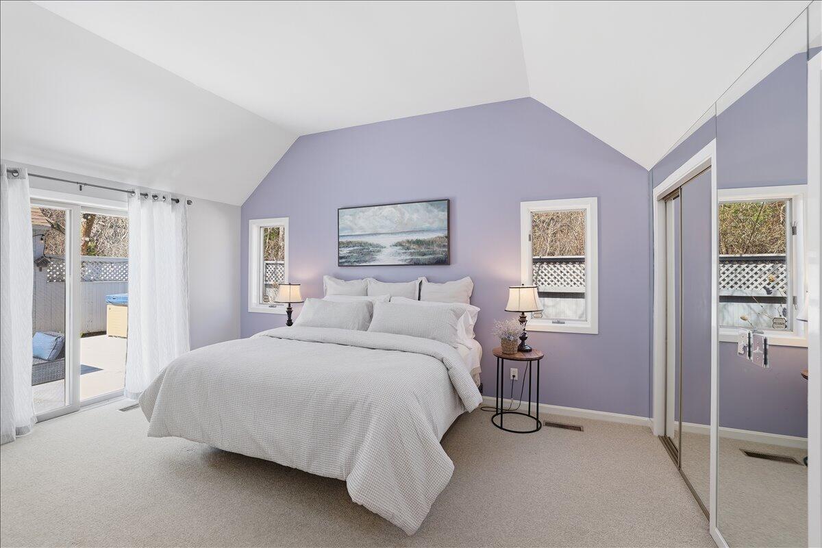 100 Mid-Iron Way, Unit 7027 Mashpee, MA 02649 - Photo 17 of 38 a bedroom with a bed and a window