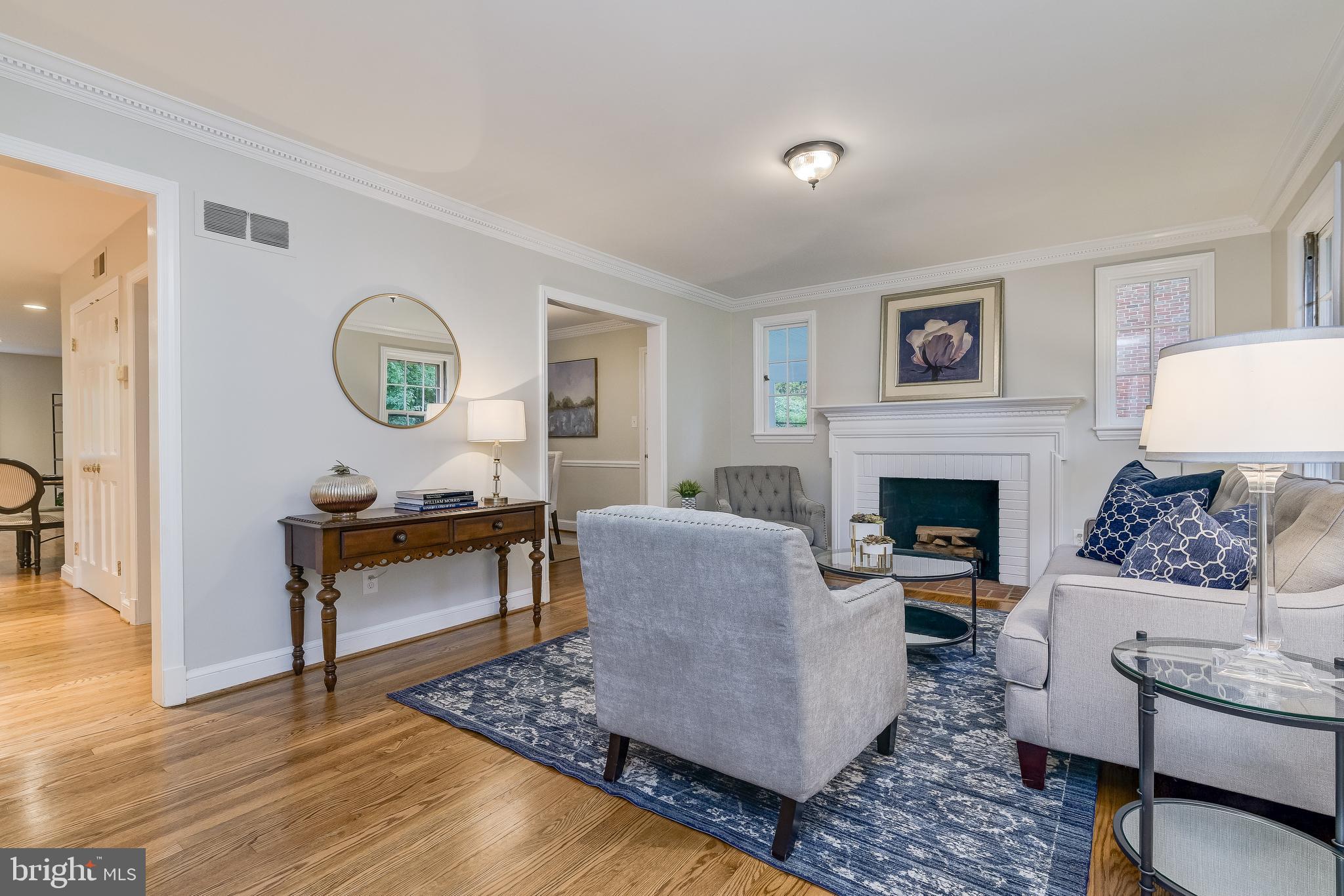 5911 Gloster Road Bethesda, MD 20816 - Photo 5 of 79 LR with crown molding, fireplace & 4 windows
